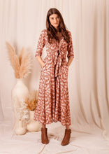 Load image into Gallery viewer, the limited edition Arcadia Bonnie Maxi dress is custom designed with bespoke prints by Fox&amp;Fallow. With a full skirt and a plunging frill neckline in a beautiful soft peach floral print.  It features a super flattering design with a v-neck tie front, gathered elasticized waist
