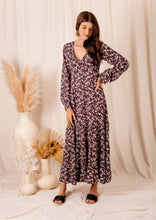 Load image into Gallery viewer, the limited edition Arcadia Elle Maxi dress is custom designed with bespoke prints by Fox&amp;Fallow. With a full skirt and a plunging frill neckline in a beautiful pale floral print against black.  It features a super flattering design with a v-neck tie front, gathered elasticized waist

