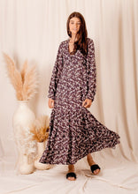Load image into Gallery viewer, the limited edition Arcadia Elle Maxi dress is custom designed with bespoke prints by Fox&amp;Fallow. With a full skirt and a plunging frill neckline in a beautiful pale floral print against black.  It features a super flattering design with a v-neck tie front, gathered elasticized waist

