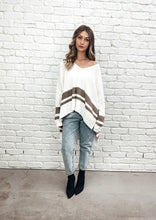Load image into Gallery viewer, The Layla Slouch Jumper by Bagira is a stunning oversized knitted jumper in a gorgeous cream and caramel cotton blend. The casual slouch style is both sassy and classy at once, this jumper has a trendy street credability.  With wide sleeves and extra long panels at the back, it is casual and feminine and looks fabulous paired with jeans, leather pants, leggings, or a mini and high boots
