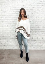 Load image into Gallery viewer, The Layla Slouch Jumper by Bagira is a stunning oversized knitted jumper in a gorgeous cream and caramel cotton blend. The casual slouch style is both sassy and classy at once with some seams reversed giving this jumper a trendy street cred.  With wide sleeves and extra long panels at the back, it is casual and feminine and looks fabulous paired with jeans, leather pants, leggings, or a mini and high boots
