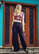 Load image into Gallery viewer, These elegant loose fitting pleated pants are versatile and very comfortable, destined to be on high rotation in your robe.  Soft tailoring in a light comfortable Viscose fabric, the Pleated Cross Over Pant are an elegant choice.  Dress them up or down to suit a social occasion, these pants are equally suitable for the office with a blouse and heals. The crossover detail at the front and soft pleats gently fall away to tulip style legs
